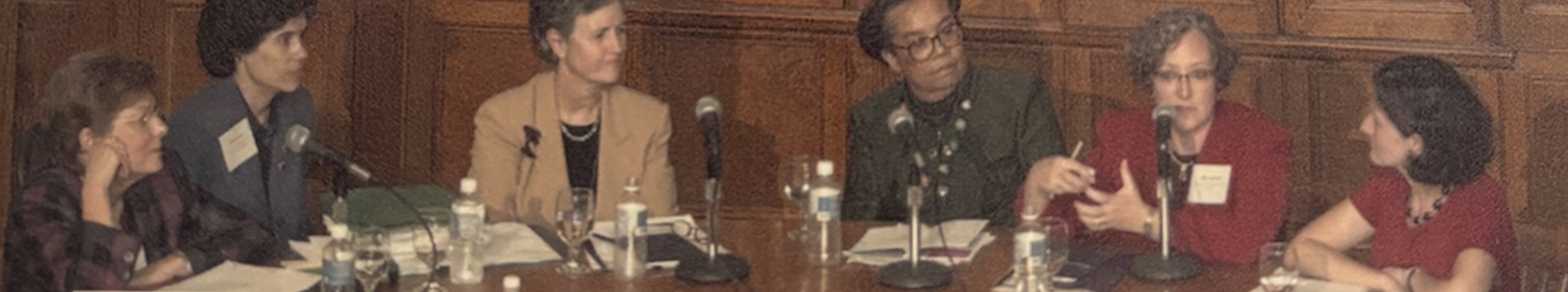 A group of Yales women faculty gathered around a table having a panel discussion